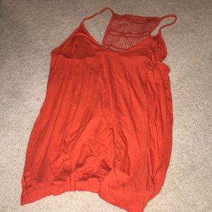 an orange tank top with a lace back